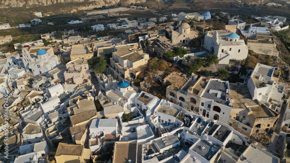 Fototapeta premium Aerial drone photo of iconic small traditional village and uphill castle of Pyrgos with great views to Santorini island Cladera, Cyclades, Greece