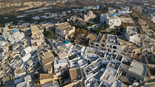 Aerial drone photo of iconic small traditional village and uphill castle of Pyrgos with great views to Santorini island Cladera, Cyclades, Greece