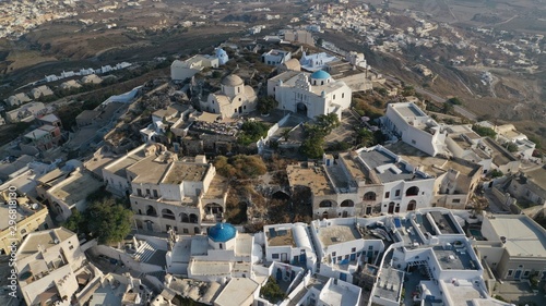 Aerial drone photo of iconic small traditional village and uphill castle of Pyrgos with great views to Santorini island Cladera, Cyclades, Greece photo