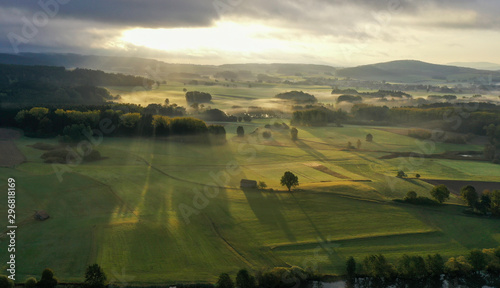beautiful autumnal landscape with ground fog in the early morning with sunbeams  © Himmelreich Photo