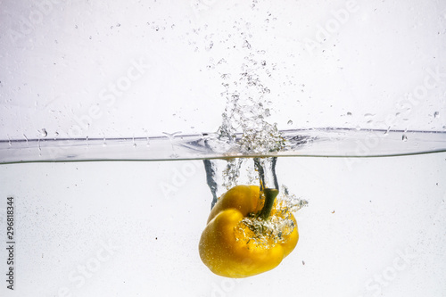 three peppers falling in water