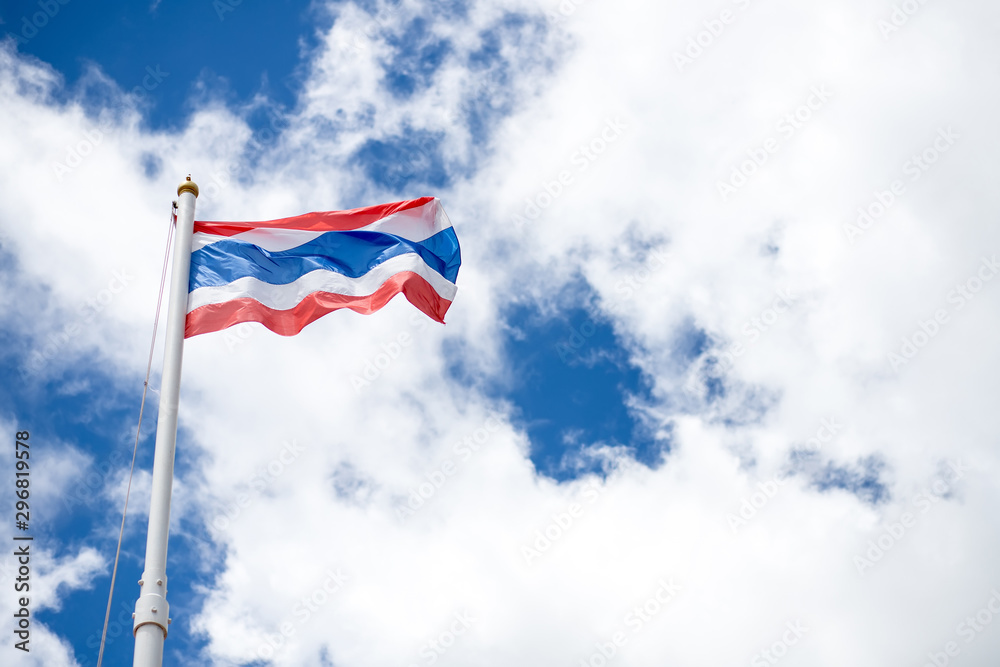 The Thai flag is flying with a beautiful background in the sky and clouds in Thailand.