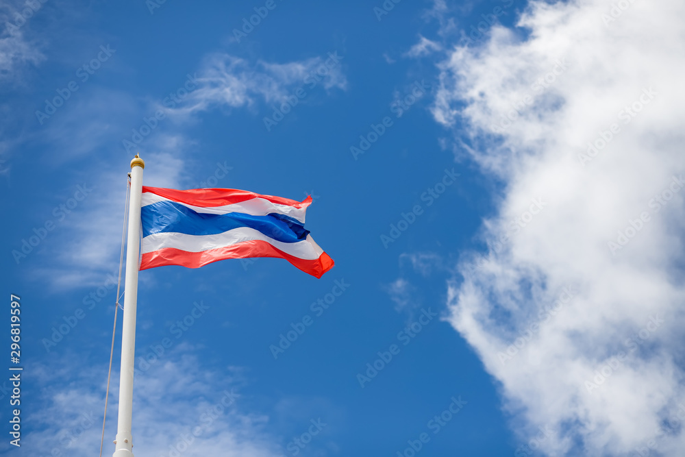 The Thai flag is flying with a beautiful background in the sky and clouds in Thailand.