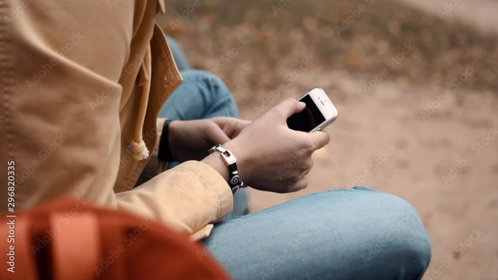 young girl sitting alone in a park with a phone young girl sitting alone in a park with a phone