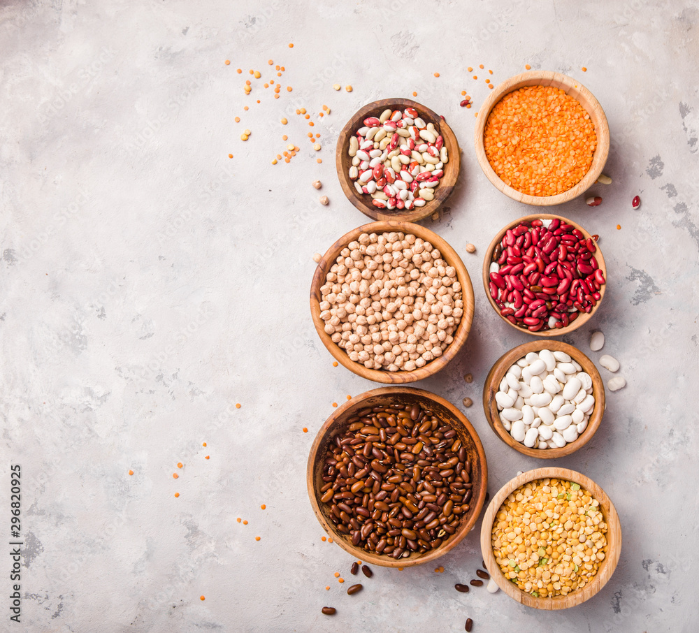 Lentils, chikpea and beans assortment in different bowls on white stone table top view. Lentils, chikpea and beans assortment in different bowls on white stone table top view.
