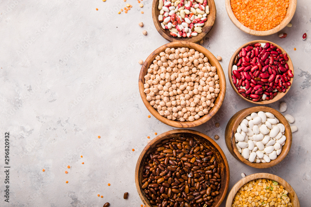 Lentils, chikpea and beans assortment in different bowls on white stone table top view. Lentils, chikpea and beans assortment in different bowls on white stone table top view.