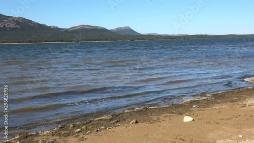 View of the Lawtonka Lake with shore line of Mountains. Waves on the lake in windy weather. photo