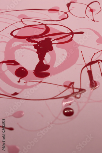 This is a photograph of Pink and Red nail polish splattered onto a Pink background