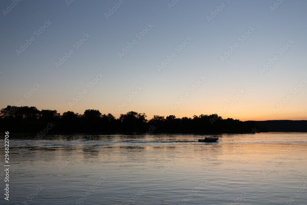 Boat on mississippi river during sunset in la crosse wisconsin