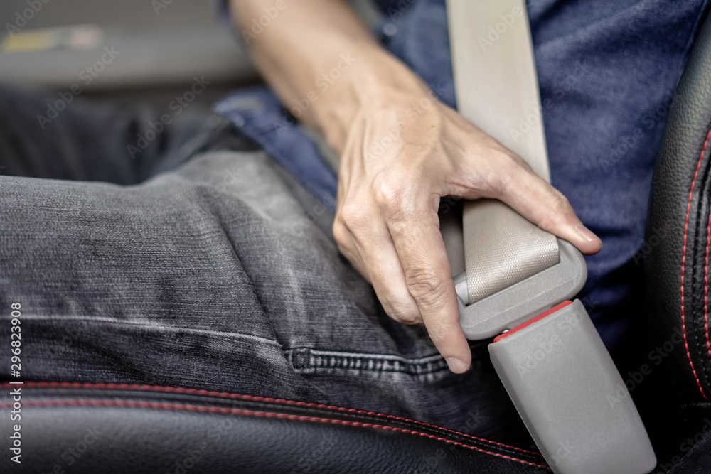 Closeup of man fastening seat belt in car, Safety belt safety first..