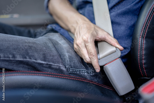 Man Sitting In Car Fastening Seat Belt  Safety belt safety first..