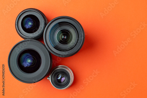 Progress of different photo lenses on a colored background, a set of old and modern photo devices for the camera