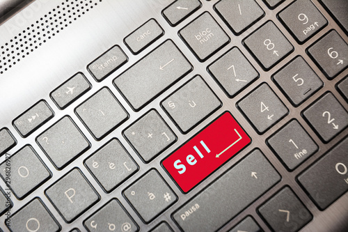 Red button on the computer with the text Sell