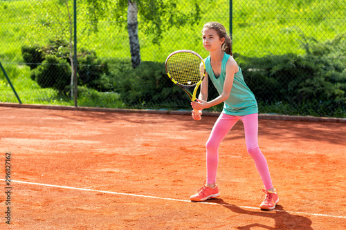 Cute little girl practicing tennis