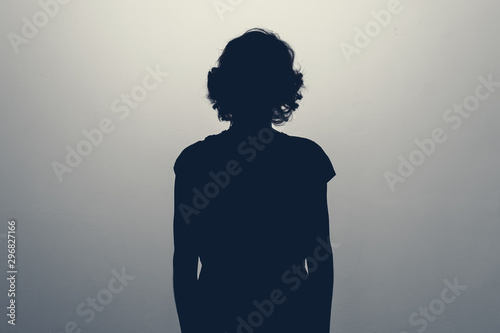 Unknown female person silhouette in studio. Concept of depression, stress or anonymous photo