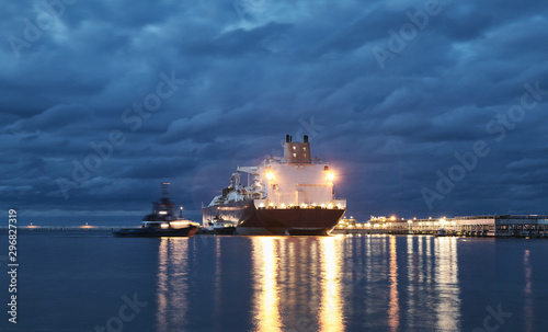 Illuminated ship in a port at dusk, lens flares effect.