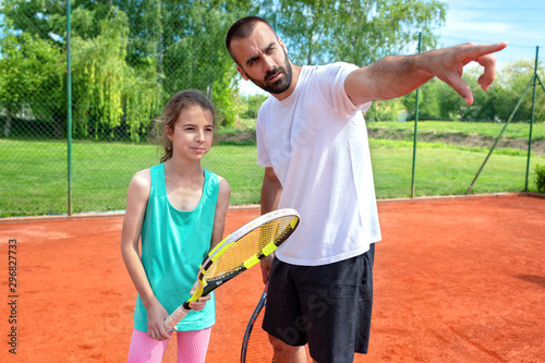 Young tennis player and her coach