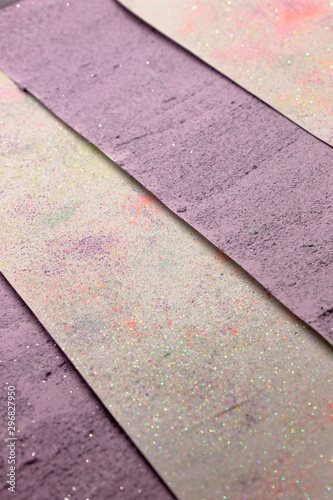 This is a photograph of a shiny textured Purple and White striped background created using acrylic paint and sprinkled with pastel colored pigments