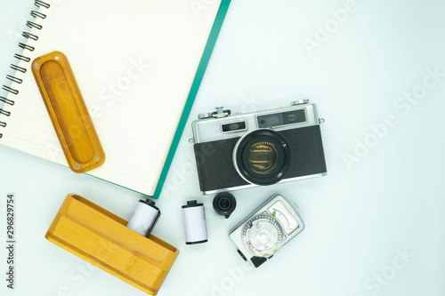 Old Vintage Film Camera and Notebook and Wooden Case of Camera Films and Vintage Light Meter Preparing for Travel Isolate on White Background