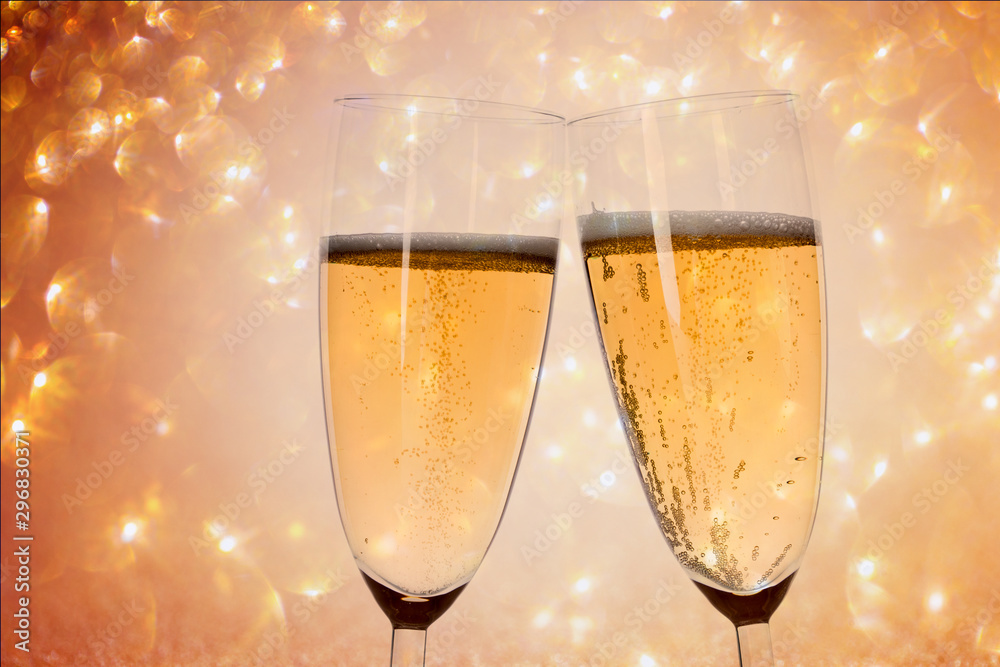 New Years eve concept with bokeh, fireworks and glasses of champagne. 