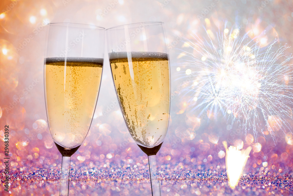 New Years eve concept with bokeh, fireworks and glasses of champagne. New Years eve concept with bokeh, fireworks and glasses of champagne.