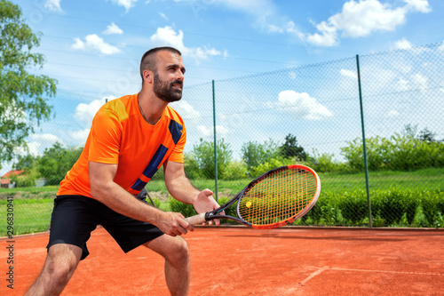 Bearded guy preparing to receive tennis serve © didesign