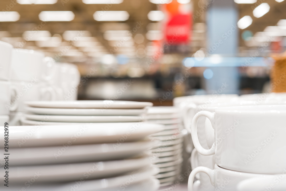 Piles of clean white dishes in the dining room. Food court in a shopping center, catering. Piles of clean white dishes in the dining room. Food court in a shopping center, catering.
