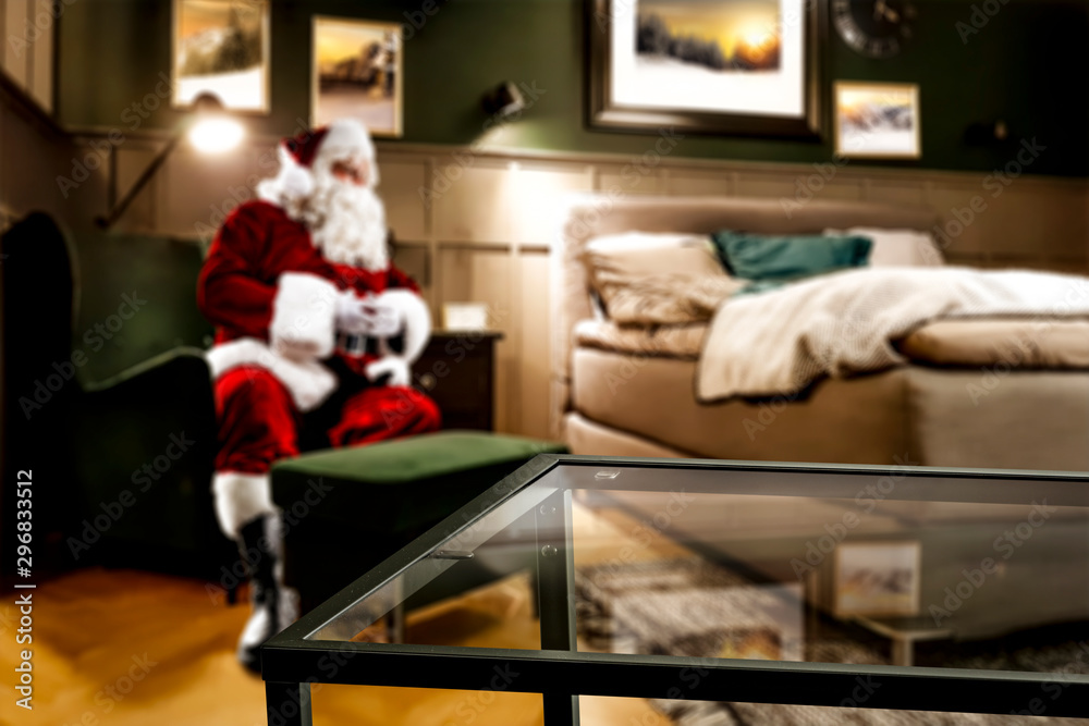 Santa Claus resting in a living room after delivering prtesents. Comfortable and cozy place in home interior.
