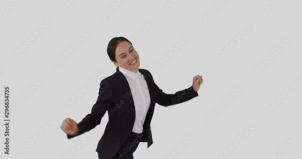 Successful businesswoman dancing over white background Successful businesswoman dancing over white background