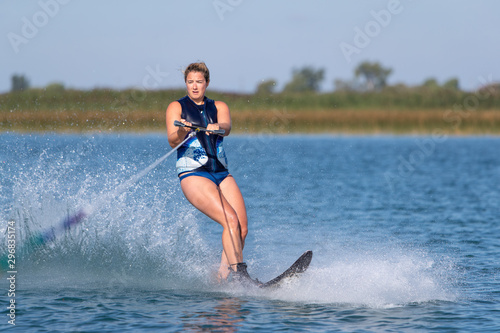 Photos A woman waterskiing on a lake.