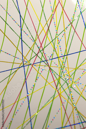 This is a photograph of a geometric background created using colourful tape and a white paper
