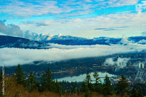 Fototapeta Naklejka Na Ścianę i Meble -  Inversion over Burrard Inlet at Port Moody with backdrop of snow-covered mountains