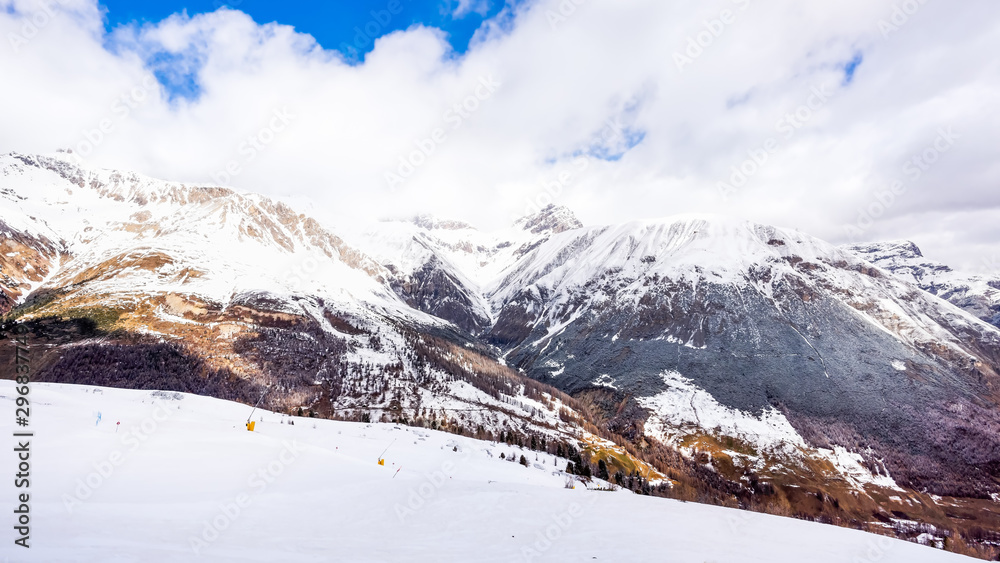 Beautiful mountains in winter, slopes and pistes with ski lifts, ski and snowboard holidays, Livigno village, Italy, Alps