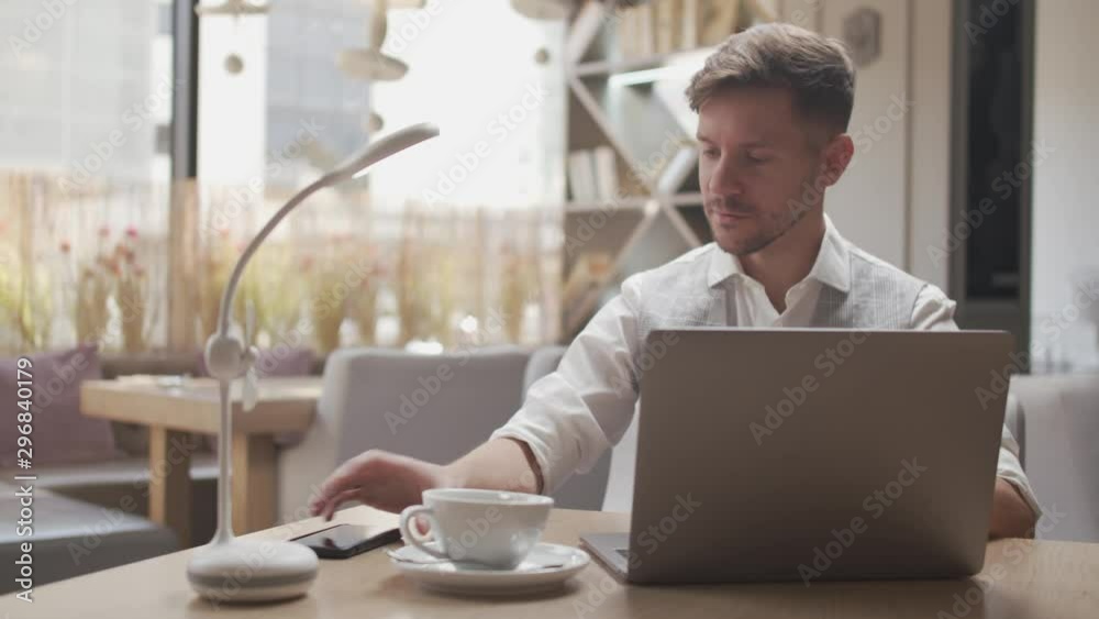 Businessman sitting and working in a cafe. Man using computer devices. Business and entrepreneurship. Businessman sitting and working in a cafe. Man using computer devices. Business and entrepreneurship.