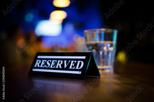 Plastic reserved plate on an arranged restaurant table