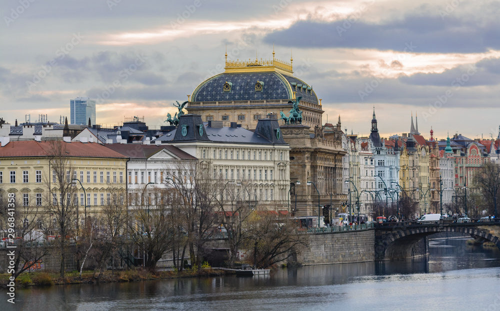 Prague National Theater is located on the Vltava Embankment. A star-blue dome is crowned with a golden crown. From the embankment side the theater is decorated with statues of Wagner and Myslbek