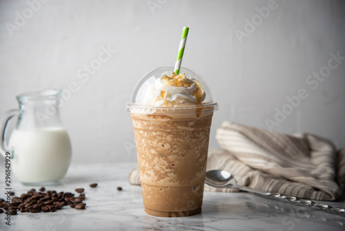 caramel frappuccino with wipped cream on marble table