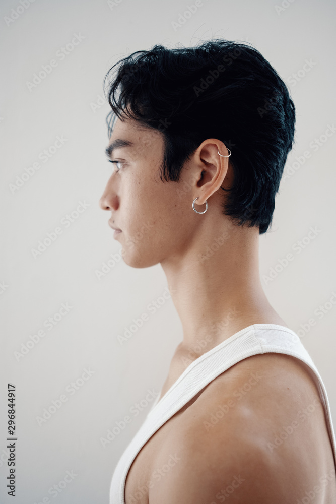 Profile of young man wearing white tank top Profile of young man wearing white tank top