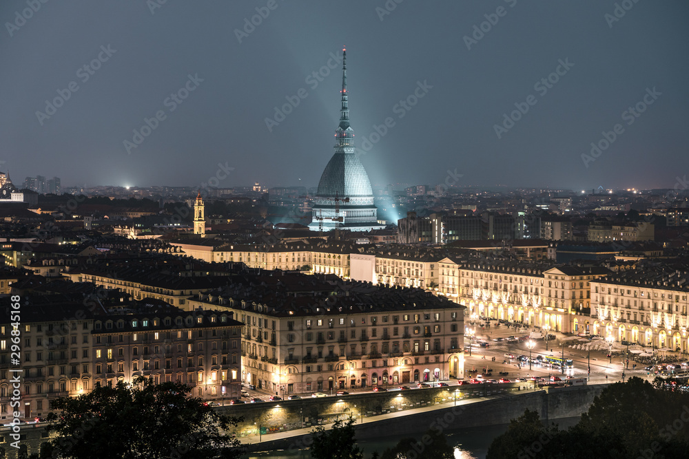 The city of Turin at sunset, great view of the Mole Antonelliana when the city  lightning up