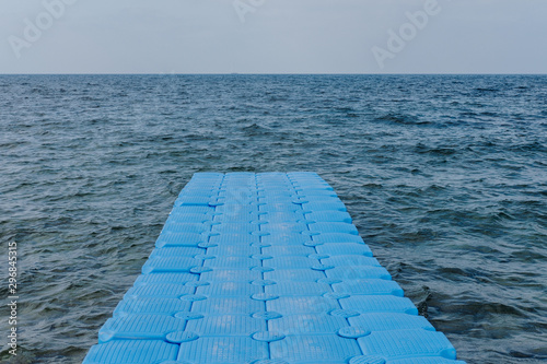 Blue plastic pier in sea photo