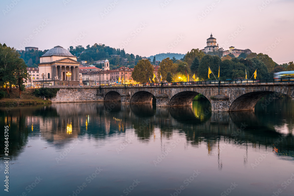 The po river and the Gran Madre di Dio Church at sunset in Turin, public transport crossing the bridge