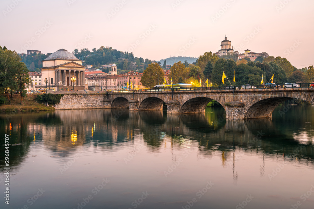 The po river and the Gran Madre di Dio Church at sunset in Turin, public transport crossing the bridge
