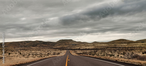 Empty road in landscape with storm clouds