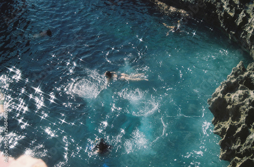 High angle view of people swimming in cove