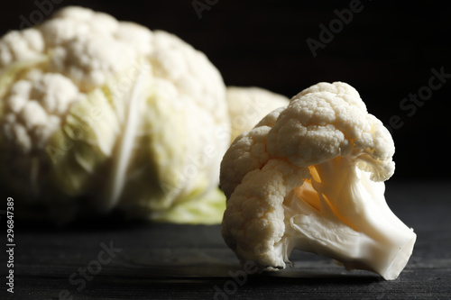 omposition of fresh, juicy cauliflower close-up on a dark kitchen table. Top view. Place for text. photo