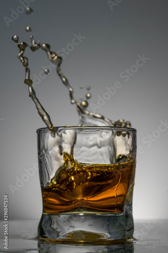 Whiskey squirts from the glass