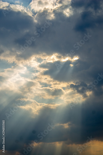 Twilight rays or stretches of the sun. Light through clouds diverge in hand. © Anelo