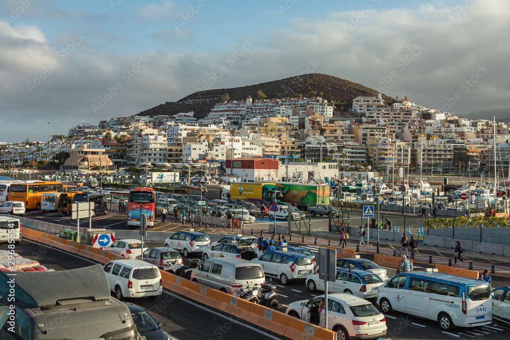 Harbor in Los Cristianos, Tenerife, Spain - May 25, 2019 - Ferry Armas to La Gomera early morning in the port of Los Cristianos docking to the harbour
