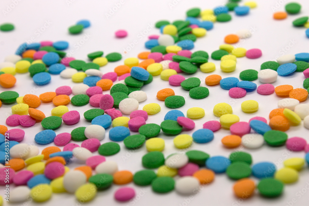 This is a photograph of colorful round sprinkles isolated on a White Background This is a photograph of colorful round sprinkles isolated on a White Background