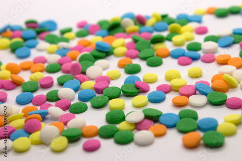 This is a photograph of colorful round sprinkles isolated on a White Background